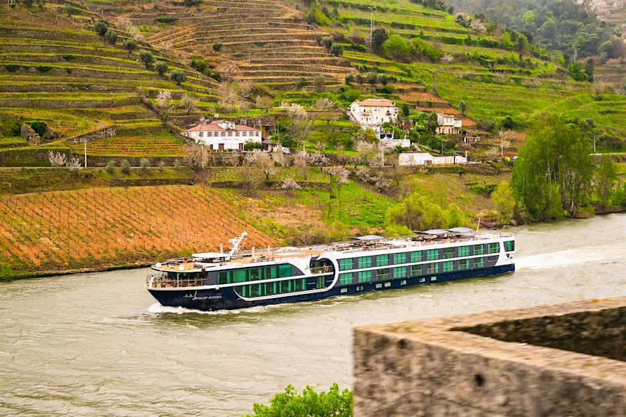 Ad for Avalon featuring a cruise ship on a river near hillside vineyardsExplore Luxury River Cruises with Avalon: Uncover the World's Hidden Gems